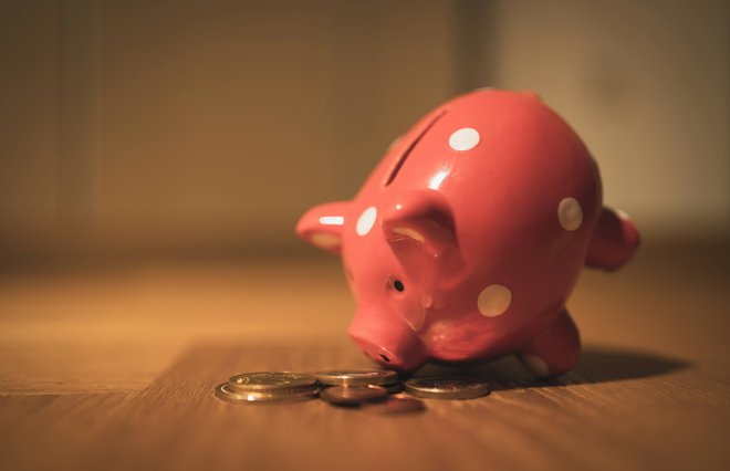 Piggy bank with coins strewn around